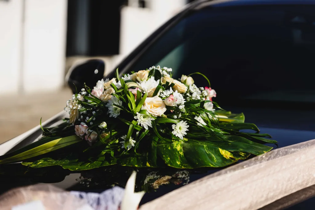 A wedding car decorated with flowers