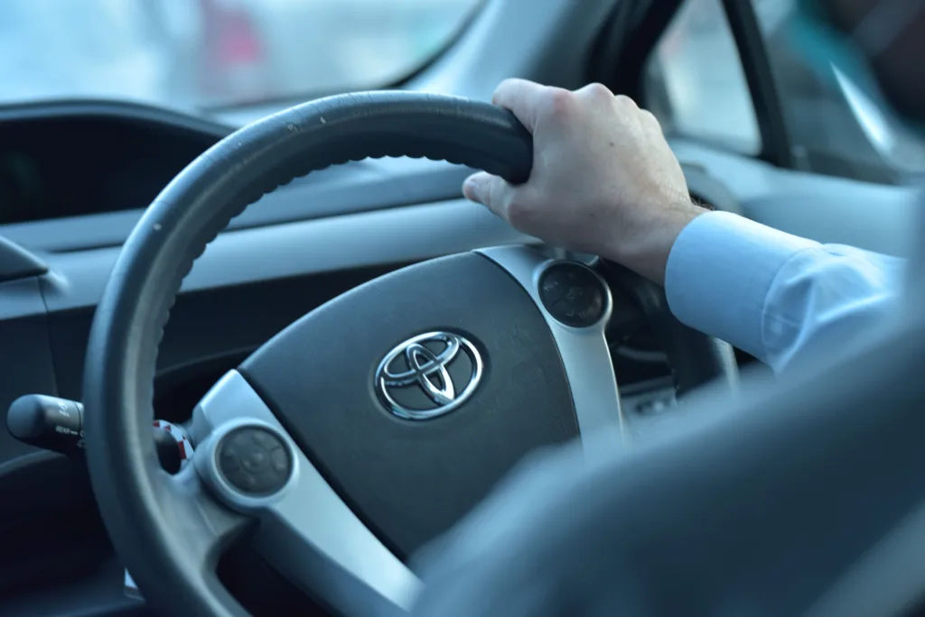 A chauffeur-driven car on a Pakistani road
