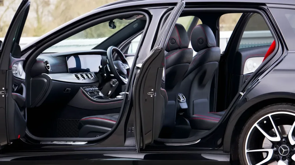 Side view of a black saloon with front and rear doors open, showing door openings, sill height and seat access
