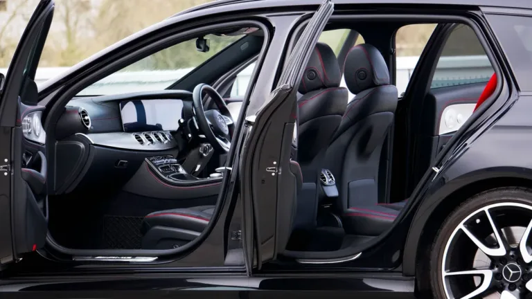 Side view of a black saloon with front and rear doors open, showing door openings, sill height and seat access