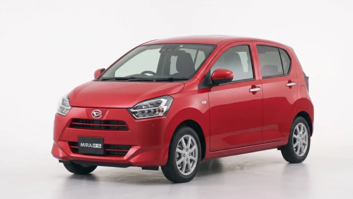 Daihatsu Mira e:S, red hatchback, studio photograph on a plain background