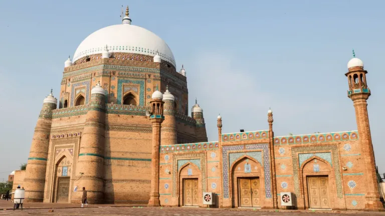 Octagonal brick mausoleum of Shah Rukn-e-Alam in Multan with white dome, corner turrets and blue tilework