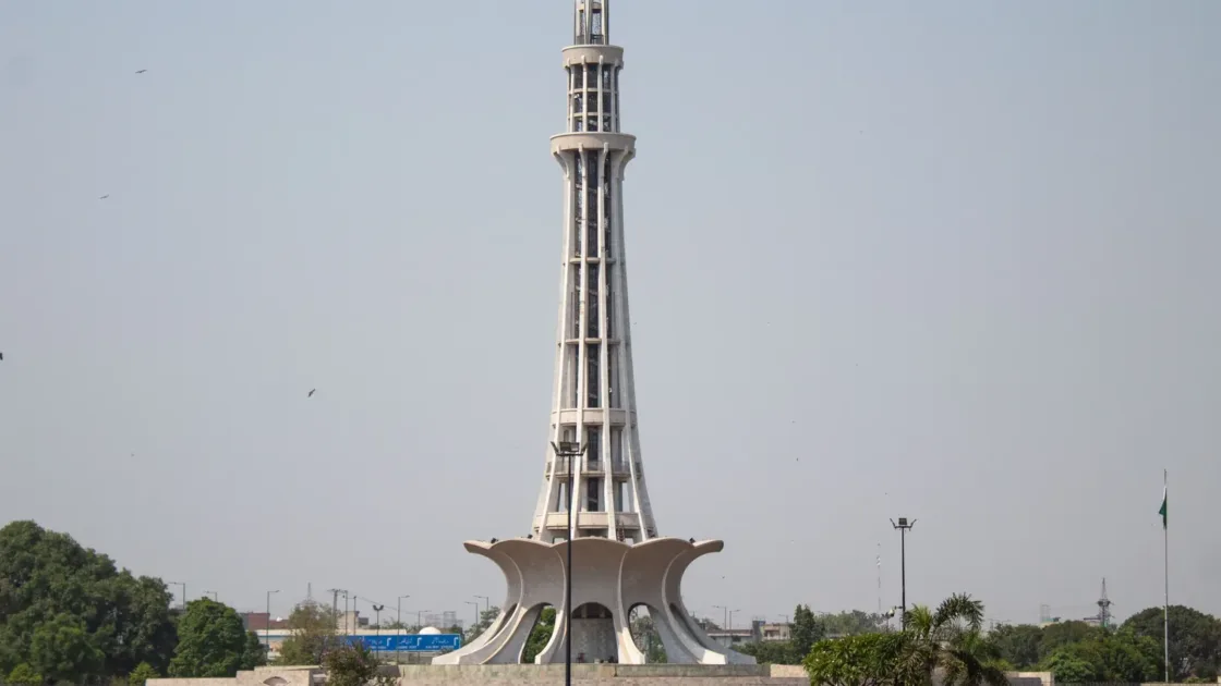 Minar-e-Pakistan rising above the green lawns of Greater Iqbal Park in Lahore on a clear day